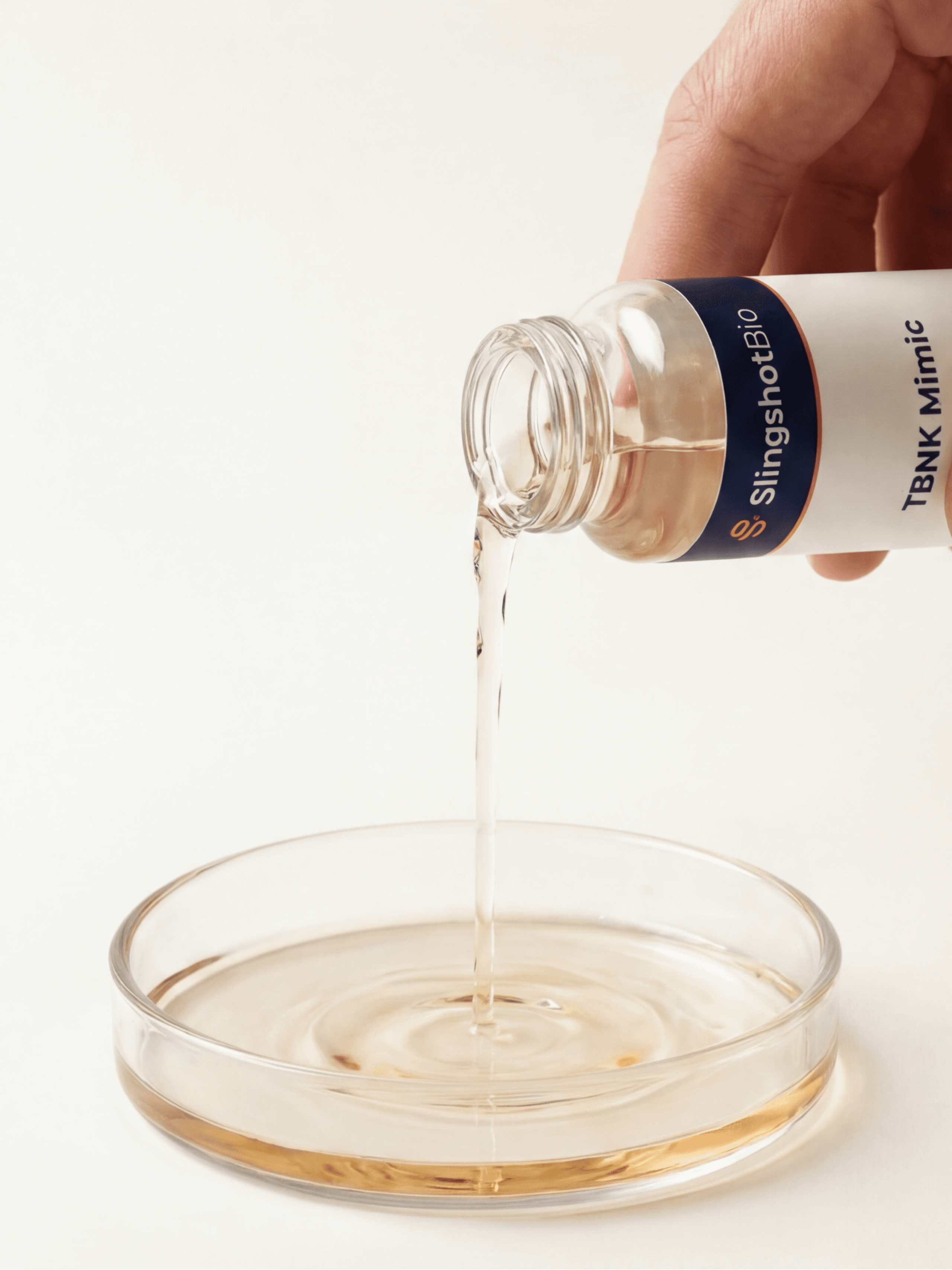 Hand pouring product into a petri dish